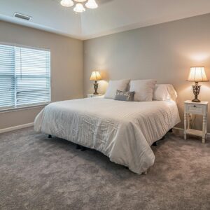 A modern and cozy bedroom with a king-size bed, soft lighting, and minimalist decor. Perfect for relaxation.